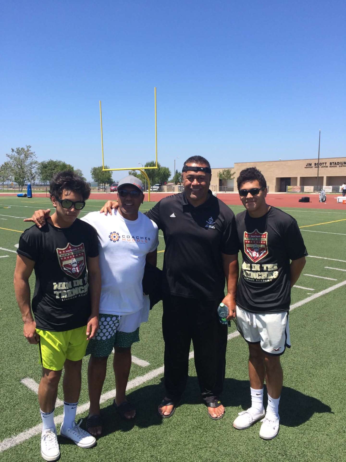 Dad and the boys with a coach at Jim Scott Stadium