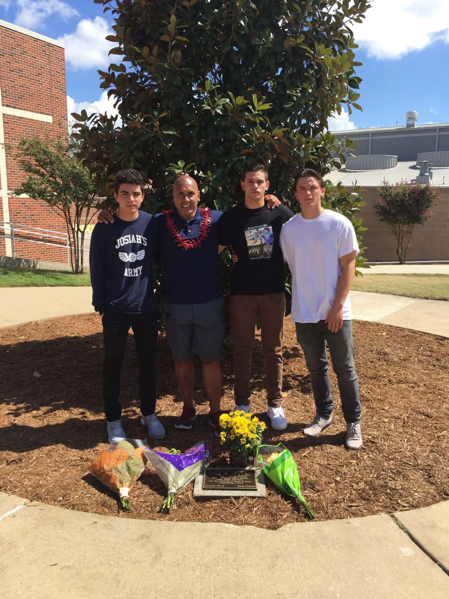 Dad with friends in Josiah's Army shirts at the memorial tree